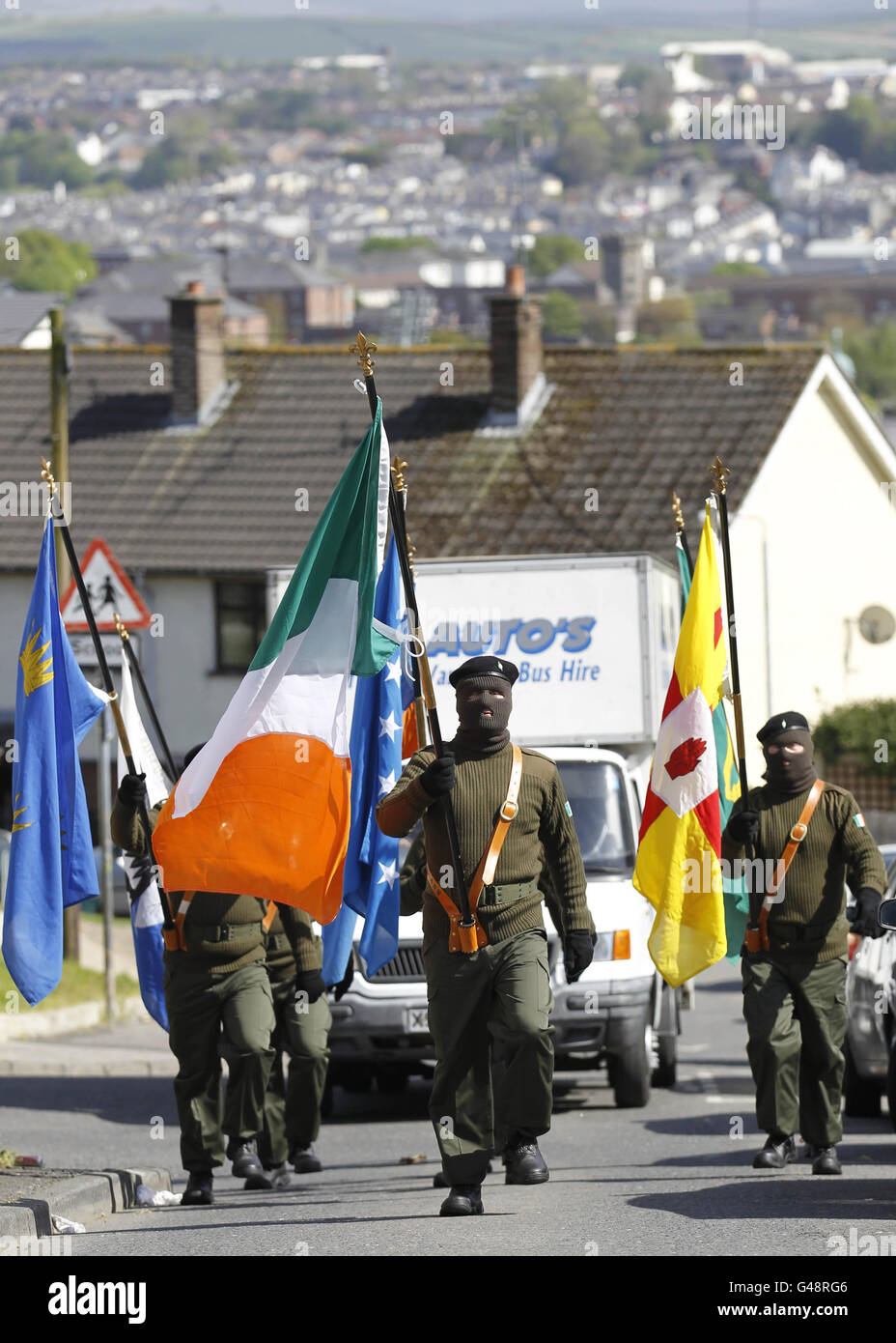 Members of the Real Irish Republican Army (RIRA) terror group parade during a 1916 Easter Rising commemoration in the Cregan Cemetery in Londonderry, Northern Ireland. Stock Photo