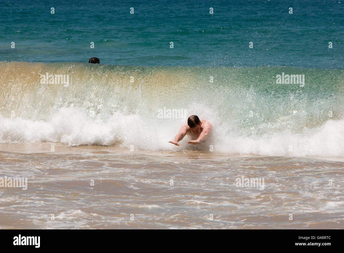Sri Lanka, Mirissa beach, man body surfing in powerful wave Stock Photo