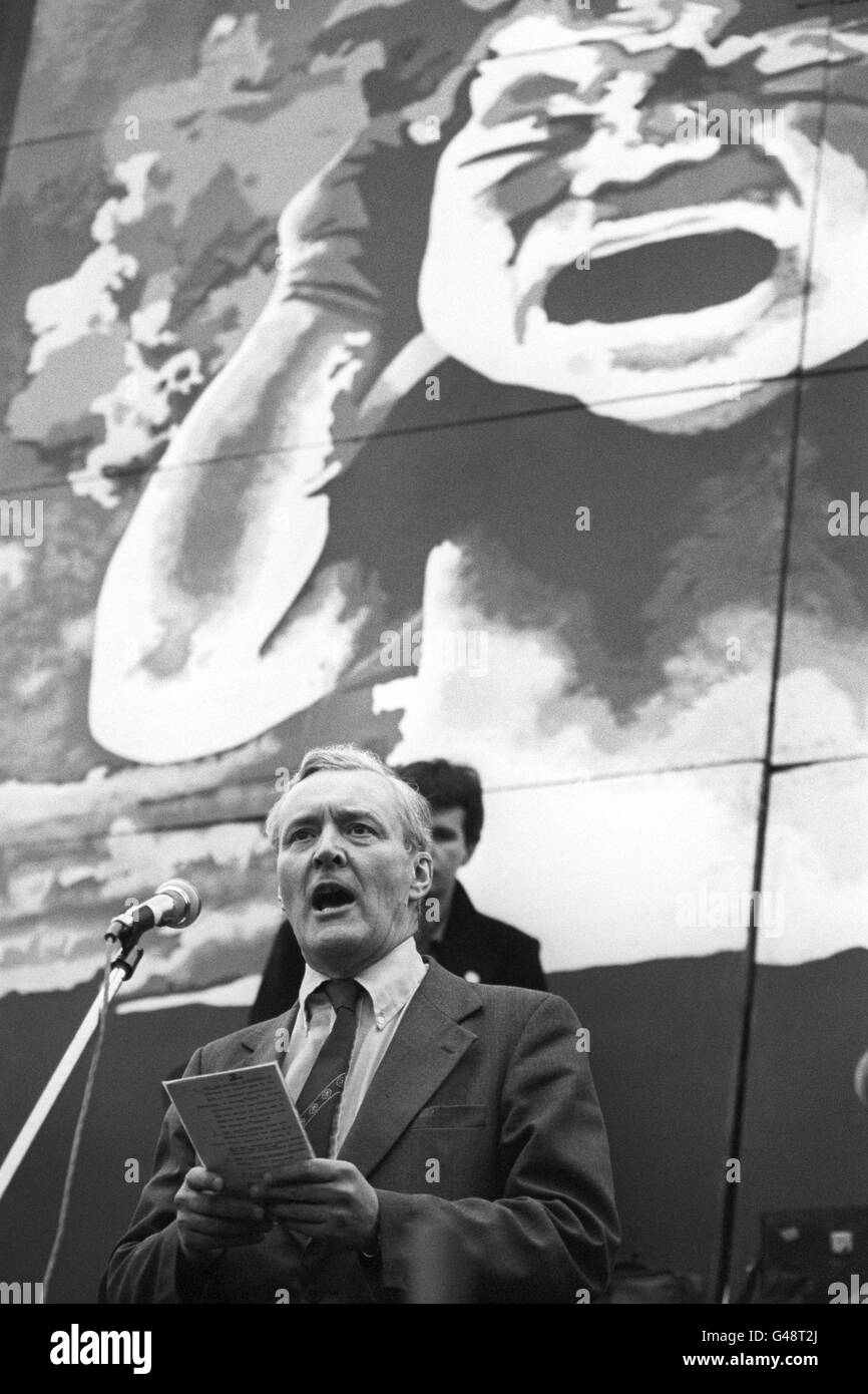 Mr Anthony Wedgwood Benn MP addresses the massive Campaign for Nuclear Disarmament (CND) demonstration in Trafalgar Square. In the background, a giant futuristic poster of nuclear explosion terrified baby. Stock Photo