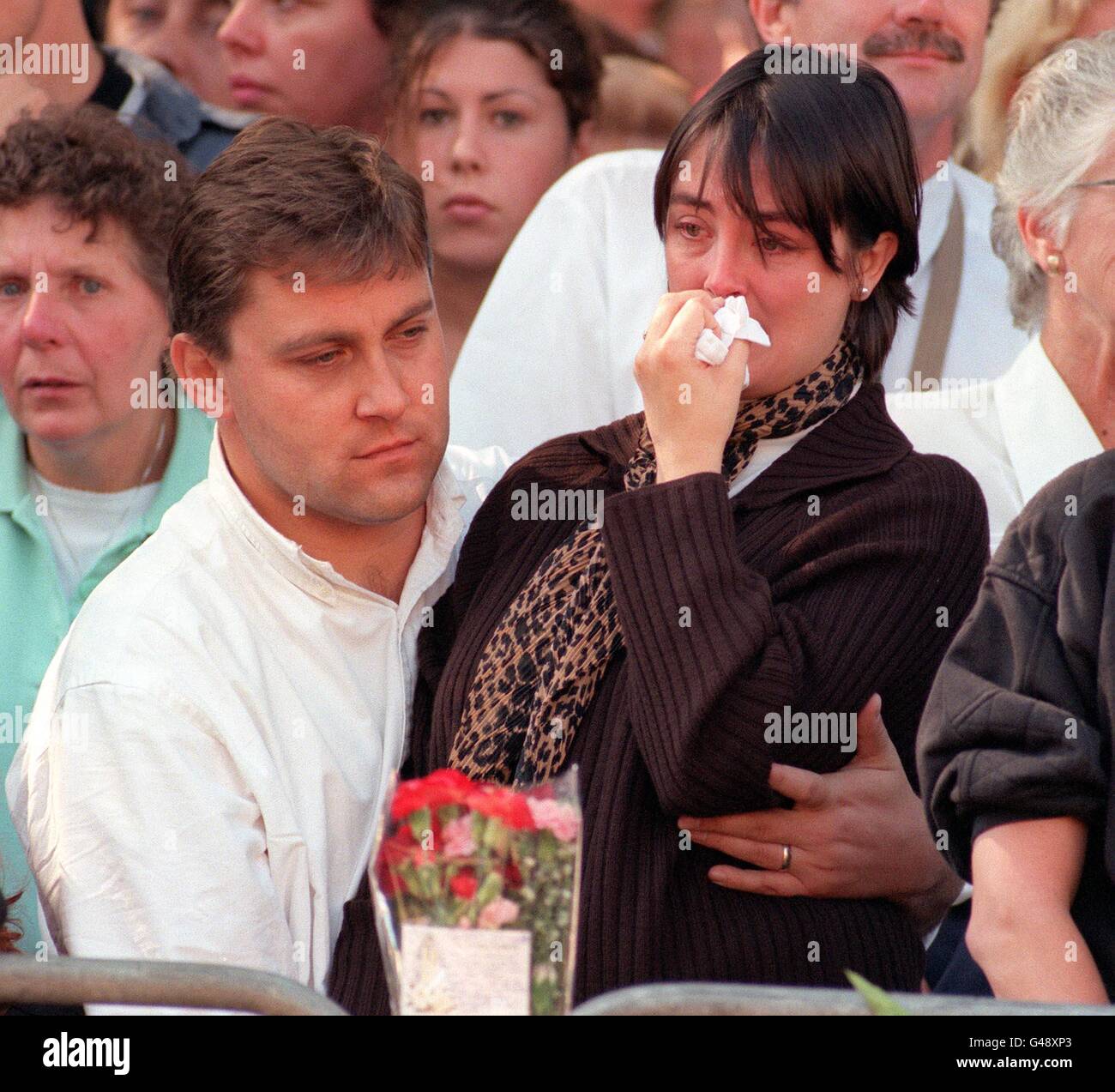 Mourners react after watching the funeral cortege of Diana, Princess of Wales, pass Horse Guards Parade en route to Westminster Abbey today (Saturday). Stock Photo