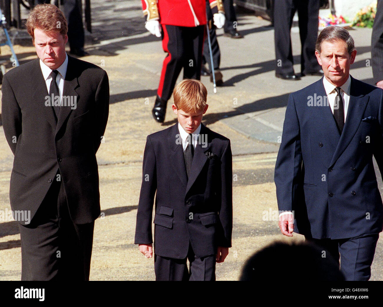 (L to R) Earl Spencer, Diana's brother, Prince Harry, her son, and Prince Charles, her former husband, join the gun carriage carrying the coffin of Princess of Wales at Marlboro Road in London during the funeral 06 September. PENNY-AFP POOL Stock Photo