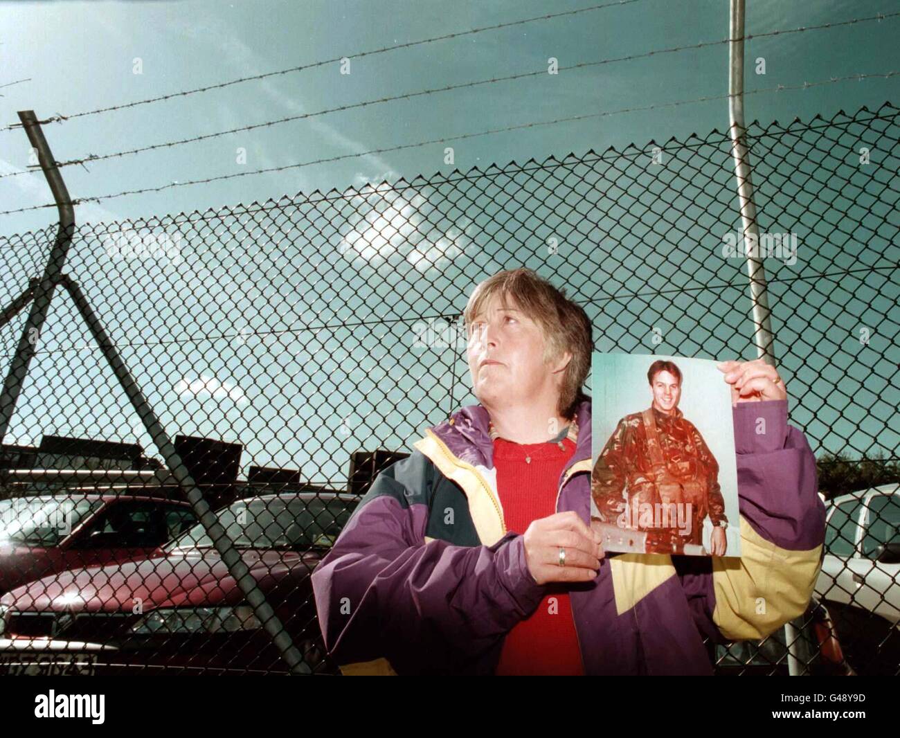 Rita Restorick, holding a photo of her son Lance Bombardier Stephen Restorick who was shot dead by the IRA in Bessbrook, Co Armagh in February 1997, stands at the gates of Castle Buildings, Stormont where the All Party Talks got under way today (Monday). Mrs Restorick had travelled to Northern Ireland to make a direct plea for all sides to talk peace. See PA story ULSTER Talks Restorick. Photo by John Giles/PA Stock Photo