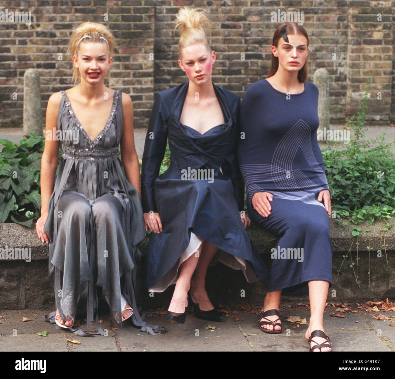Three models wear designs by three of the six nominees for 'British Designer of the Year 1997', who were announced at a news conference in London today. The winner, voted for by key press and buyers from the fashion industry, will be announced at the Lloyds Bank British Fashion Awards on October 22 at the Royal Albert Hall. (L-R) Lana models a dress by design duo Clements Ribeiro; Kate Lillicrap wears an evening dress by Vivienne Westwood and Amy Weir is dressed in a design by Hussein Chalayan. Stock Photo