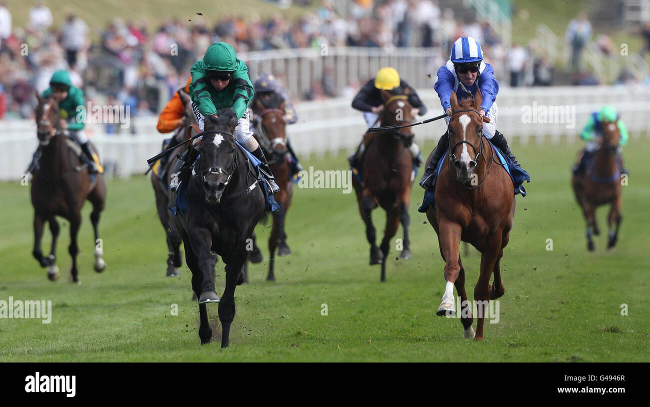Colombian ridden by William Buick (green cap) wins The Merseyrail Maiden Stakes ahead of second placed Tanfeeth ridden by Richard Hills in a tight finish during the totesport Cup Day at Chester Racecourse. Stock Photo