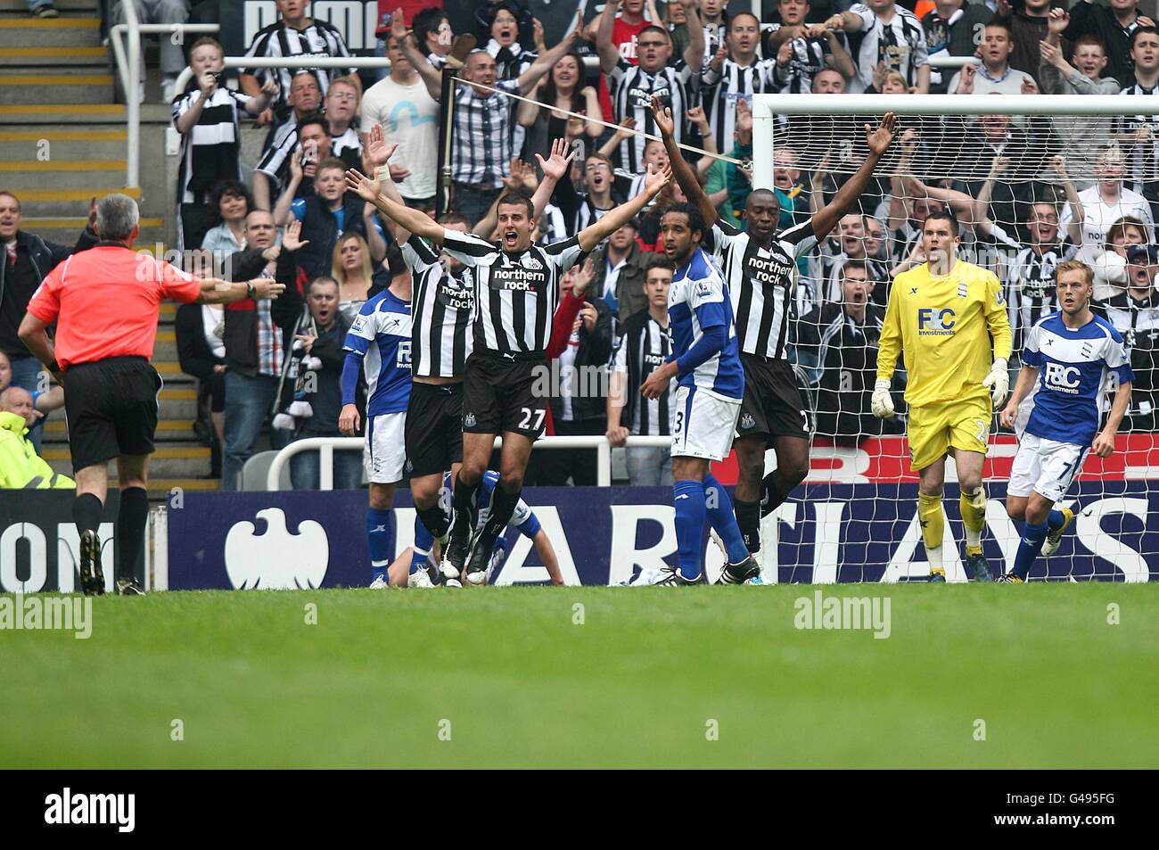 Newcastle United players react furiously after an incident that sees Birmingham City's Liam Ridgewell hand-balling in the area leading to referee Chris Foy (left) awarding a penalty and a dismissal for the Birmingham player Stock Photo