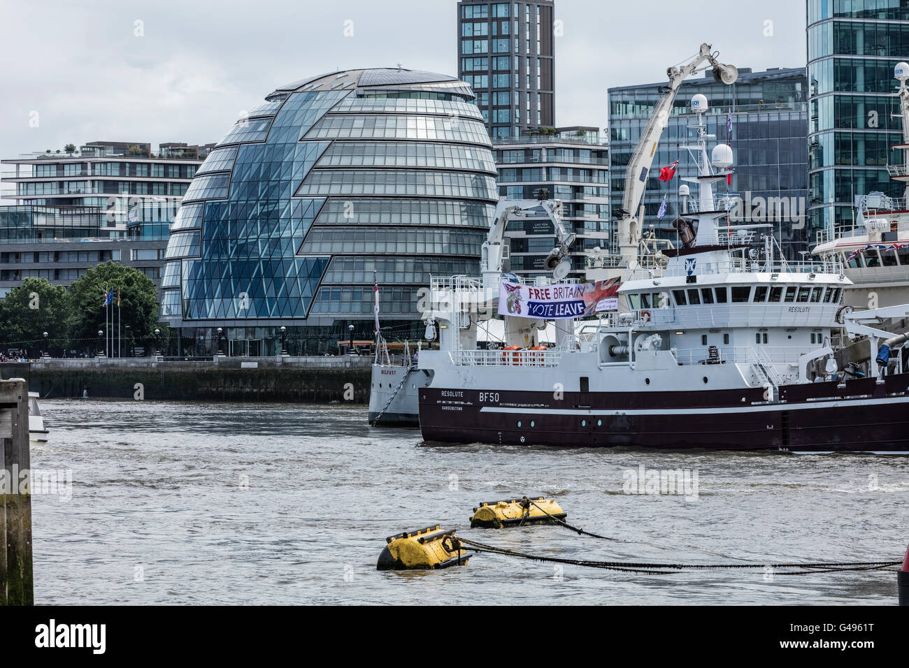 Fishing boats on the River Thames in London in front of City Hall the