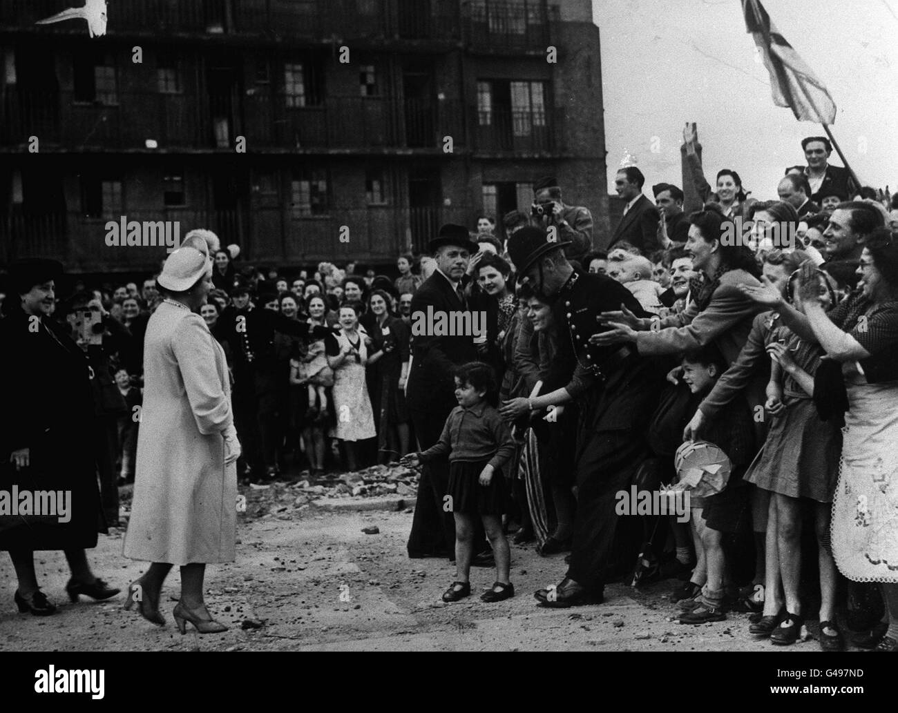 Queen Elizabeth (later the Queen Mother) gets a warm welcome from East Enders at Vallence Road in Stepney, London during her visit to areas affected by Luftwaffe air raids during the Blitz. Stock Photo