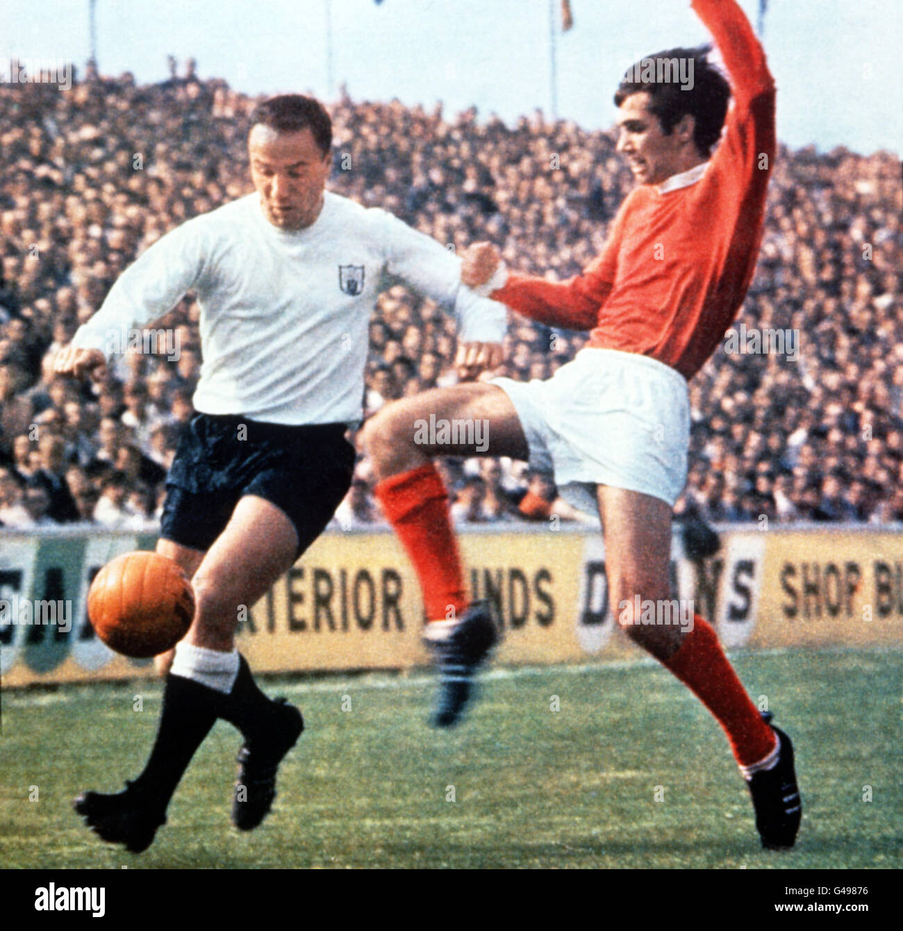 Undated file of England footballing star George Cohen (left) playing for his club side Fulham against youthful Man Utd star George Best. Cohen, one of the English heroes who took their country to World Cup glory in 1966, is to sell his prized medal it was announced today (Friday). See PA Story SPORTS Cohen. Stock Photo