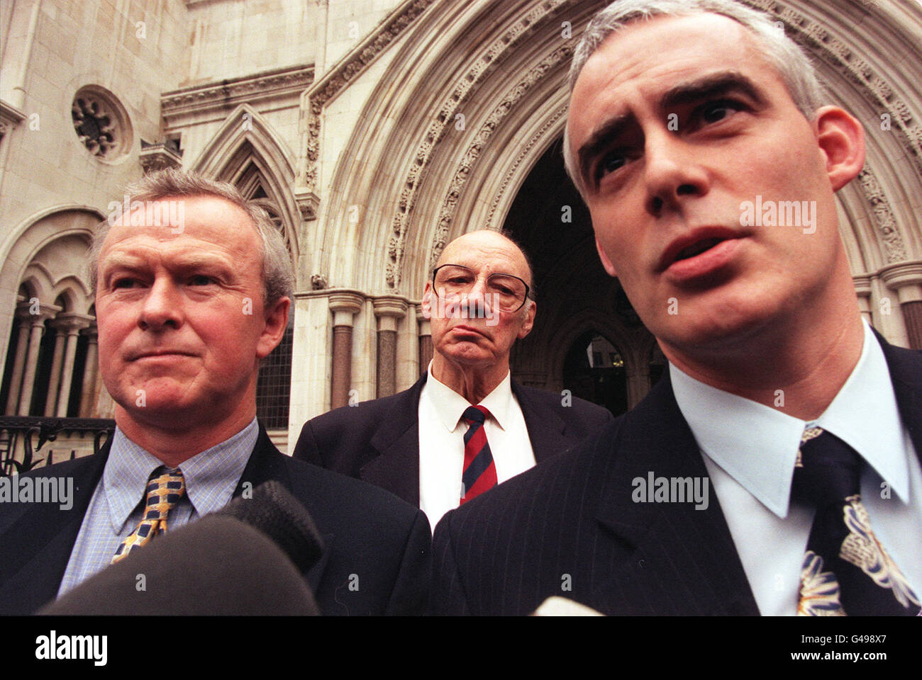 Anti-smoking campaigner Ernest Jones, who has been treated for lung cancer, is flanked by solicitors Martin Day and John Pickering (right) outside the High Court in London today (Thursday), where legal teams representing 43 cancer victims seeking compensation from tobacco companies were reassured by senior judges they will not be liable for huge legal costs if they lose. See PA story COURTS Smoking. Photo by Peter Jordan/PA Stock Photo