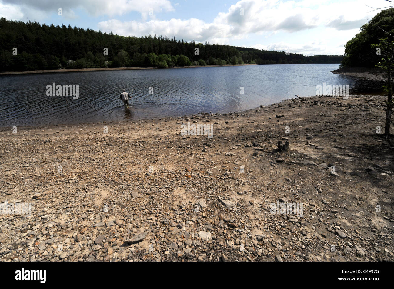 A fly fisherman (name not given) has a longer than usual walk to the water's edge at Fewston Reservoir near Harrogate which has seen a fall in levels due to the dry weather experienced by the UK. PRESS ASSOCIATION Photo. Picture date: Thursday May 19, 2011. Photo credit should read: John Giles/PA Wire Stock Photo