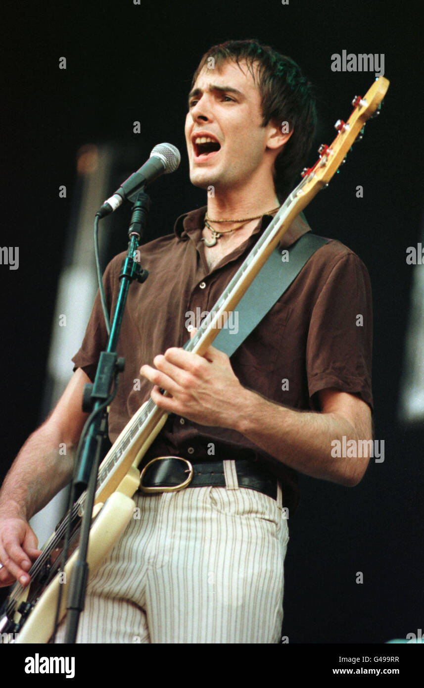 Kula Shaker bass player performing during V97 concert at Hylands Park Chelmsford. Stock Photo
