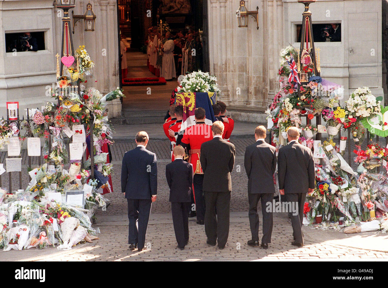 The coffin of Diana, Princess of Wales is carried into Westminster Abbey by the bearer party of Welsh Guardsmen for her funeral this morning (Saturday), followed by (l/r) the Prince of Wales, Prince Harry, the Earl Spencer, Prince William and the Duke of Edinburgh. Stock Photo