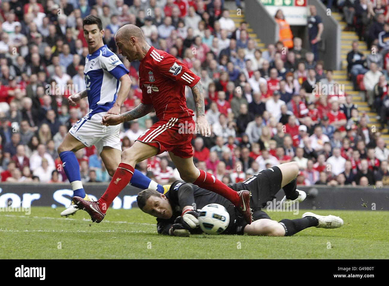 Soccer - Barclays Premier League - Liverpool v Birmingham City - Anfield. Liverpool's Raul Meireles is denied by Birmingham City goalkeeper Colin Doyle (floor) Stock Photo