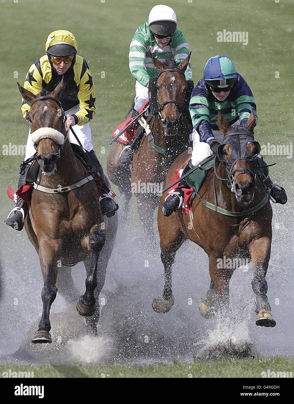 Horses clear the water in the Kildare Hunt Club Fr Sean Breen Memorial Chase For The Ladies Perpetual Cup during the Boylesports.com Champion Chase Day at Punchestown Racecourse, Naas, Ireland. Stock Photo