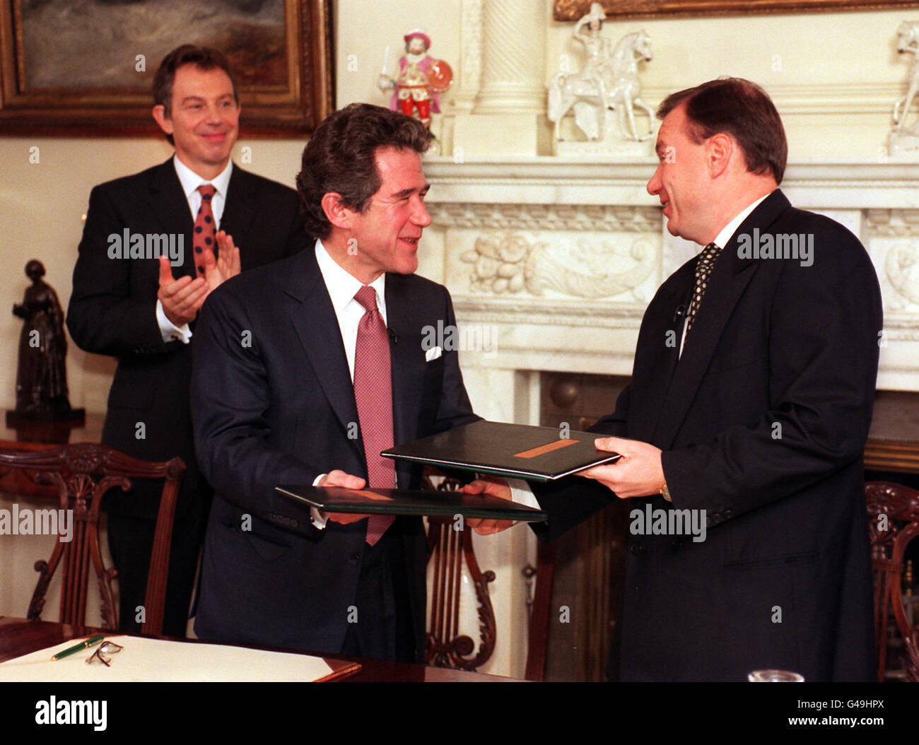 Left to right: Prime Minister Tony Blair applauds as John Browne, chief executive of BP, exchanges a signed trade treaty with Vladimir Potanin, chairman of the Russian bank, Unexim, at No. 10 Downing Street this morning (Tuesday). WPA Rota picture by Tony Harris/PA Stock Photo