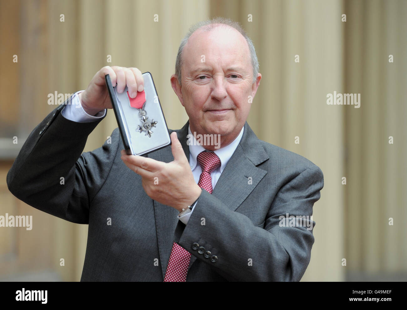 Clive Stone poses in the Quadrangle of Buckingham Palace, London after being presented with a member of the British Empire (MBE) medal by The Prince of Wales. Stock Photo