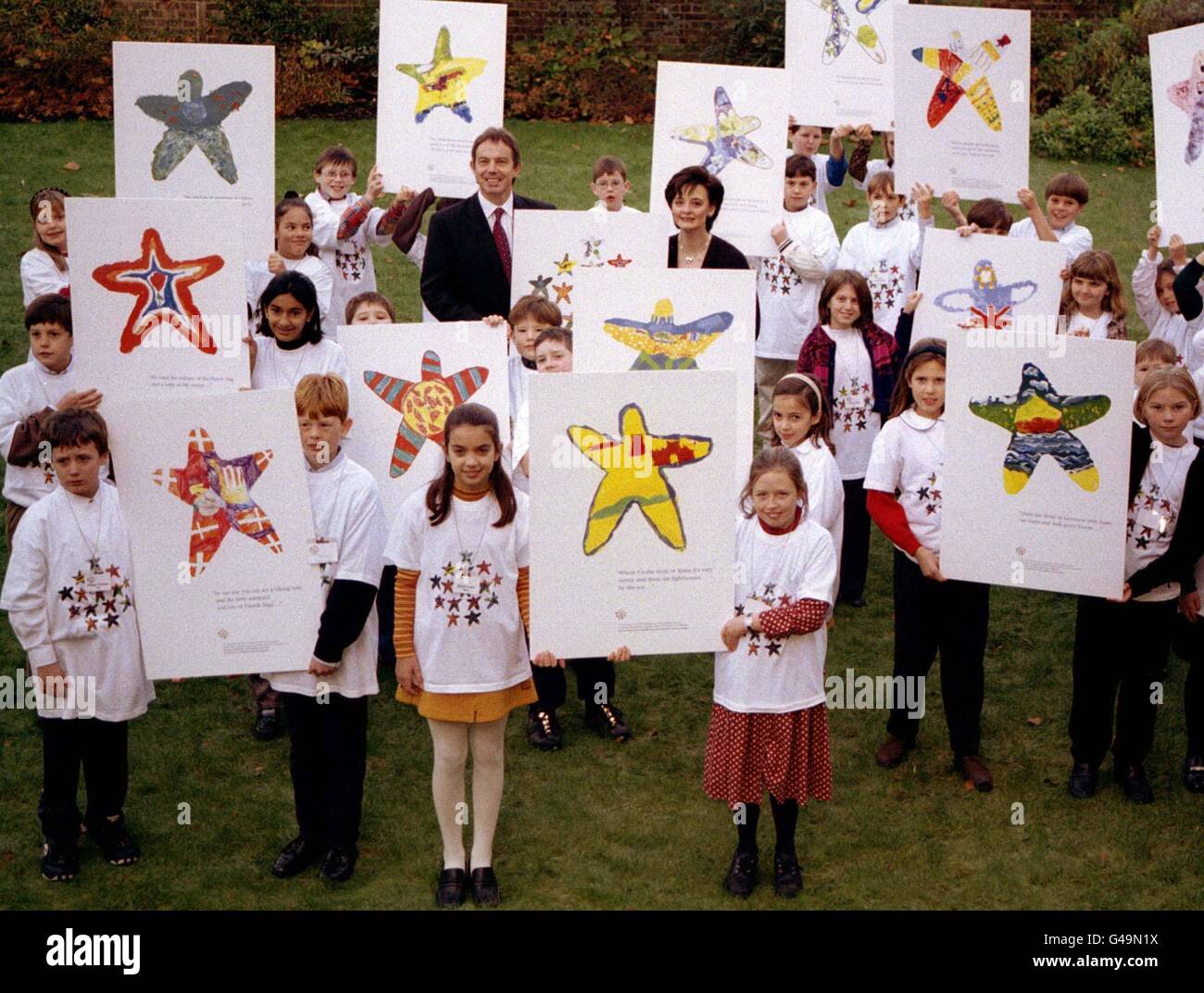 Prime Minister Tony Blair and his wife Cherie Booth pose with children from the fifteeen member states of the European Union who helped to design the logo for the UK presidency. * The premier said the logo summed up his message for the European Presidency, insisting that the member states should work together as a team. Stock Photo