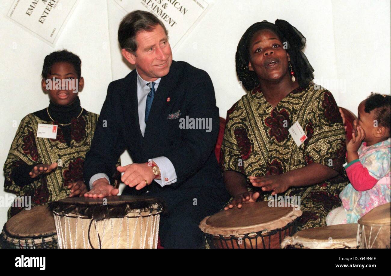 The Prince of Wales plays on a bongo drum with Emashi traditional