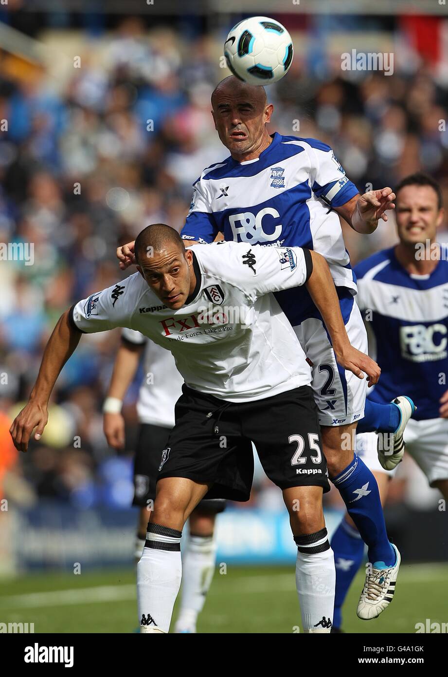 Soccer - Barclays Premier League - Birmingham City v Fulham - St Andrew's. Birmingham City's Stephen Carr (top) and Fulham's Bobby Zamora (bottom) battle for the ball in the air Stock Photo