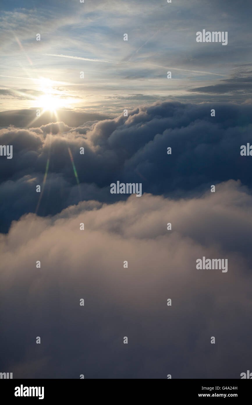 Sunburst above the clouds from an aircraft Stock Photo