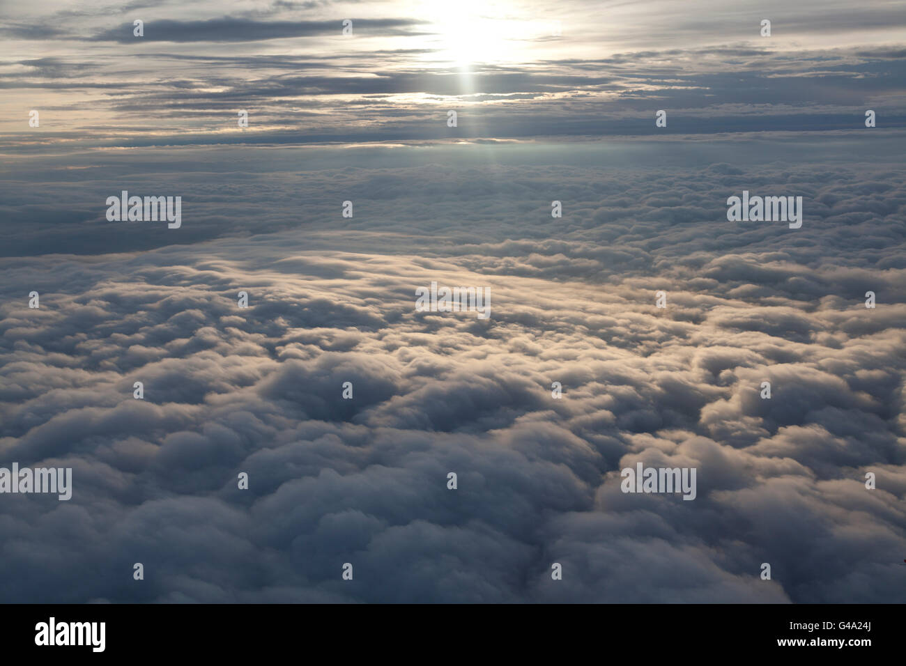 Blanket of clouds from aircraft with patch of sunlight Stock Photo