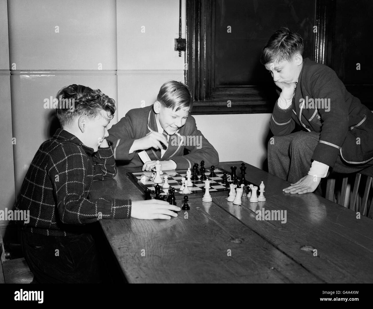 Chess - Brighton and Hove Boys' Chess Tournament - Technical College, Brighton. Left to right; Roland Field (12), W.D Bracher (13) and CJ Cheesman (14) during the chess tournament Stock Photo