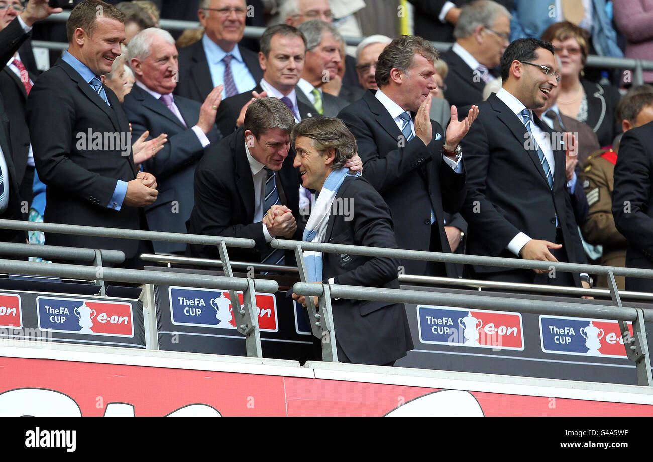 Manchester City Manager Roberto Mancini Right Is Congratulated By Football Administration Officer Brian Marwood After Winning The Fa Cup Stock Photo Alamy