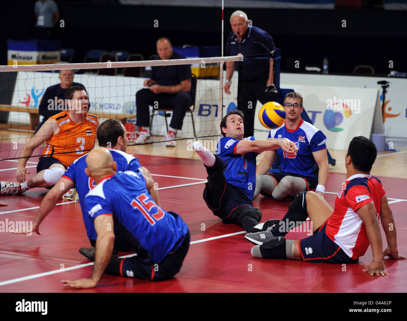 Great Britain's Rob Richardson (centre) tries to return the ball during the Sitting Volleyball Exhibition Match against The Netherlands during the Paralympic World Cup in Manchester. Stock Photo
