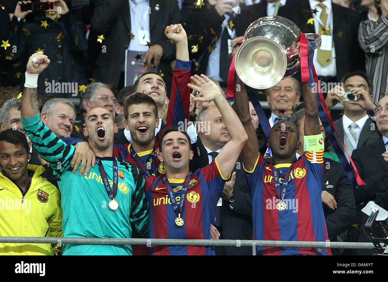 Barcelona captain Eric Abidal (right) lifts the UEFA Champions League  trophy with team mates Victor Valdes (left) and Xavi Hernandez Stock Photo  - Alamy