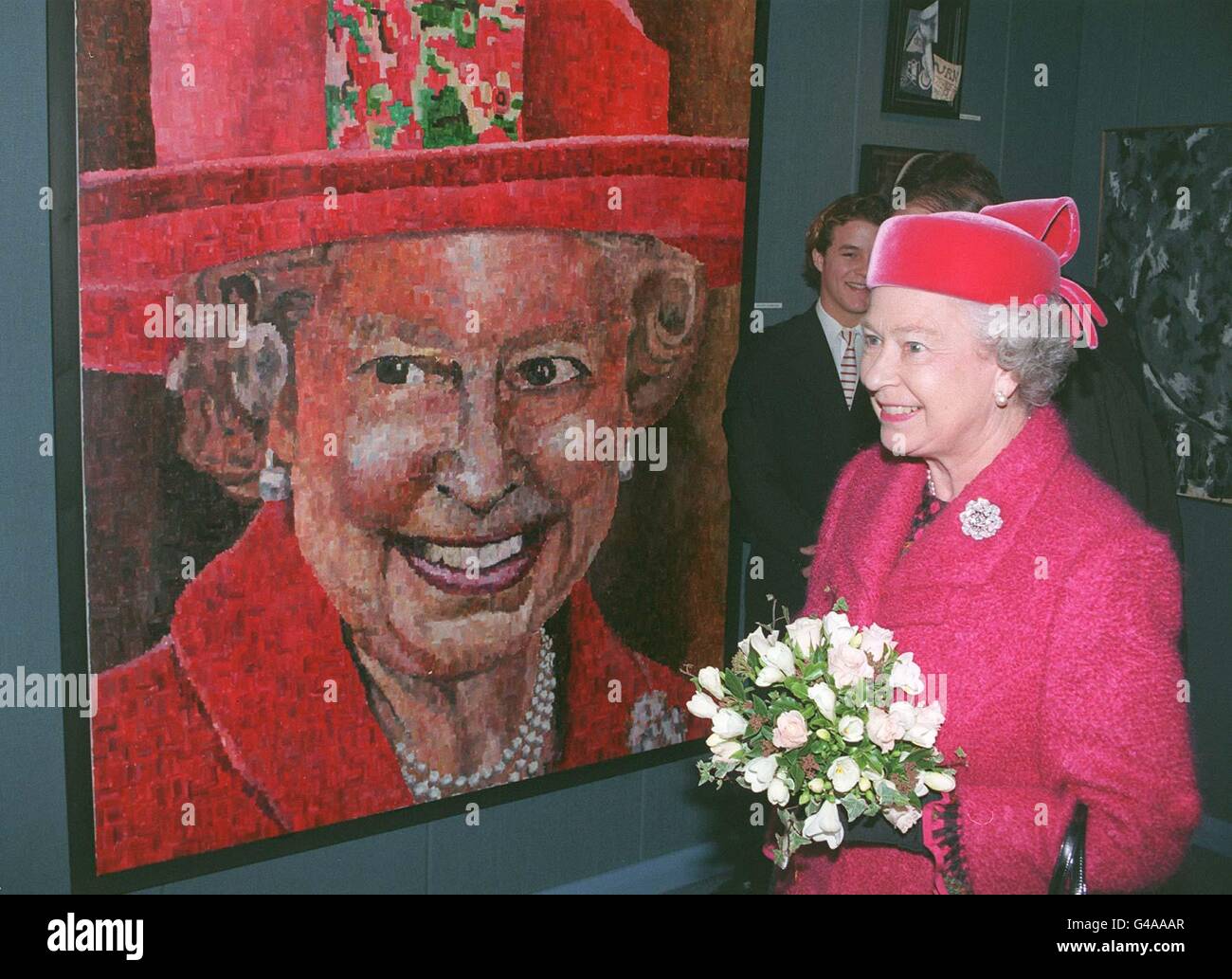 The Queen admires a portrait of herself painted by sixth former Peter Hawkins (at rear), during a visit with the Duke of Edinburgh to Radley College, Abingdon, Oxon, to open a new building today (Thursday). WPA Rota picture by John Stillwell/PA Stock Photo