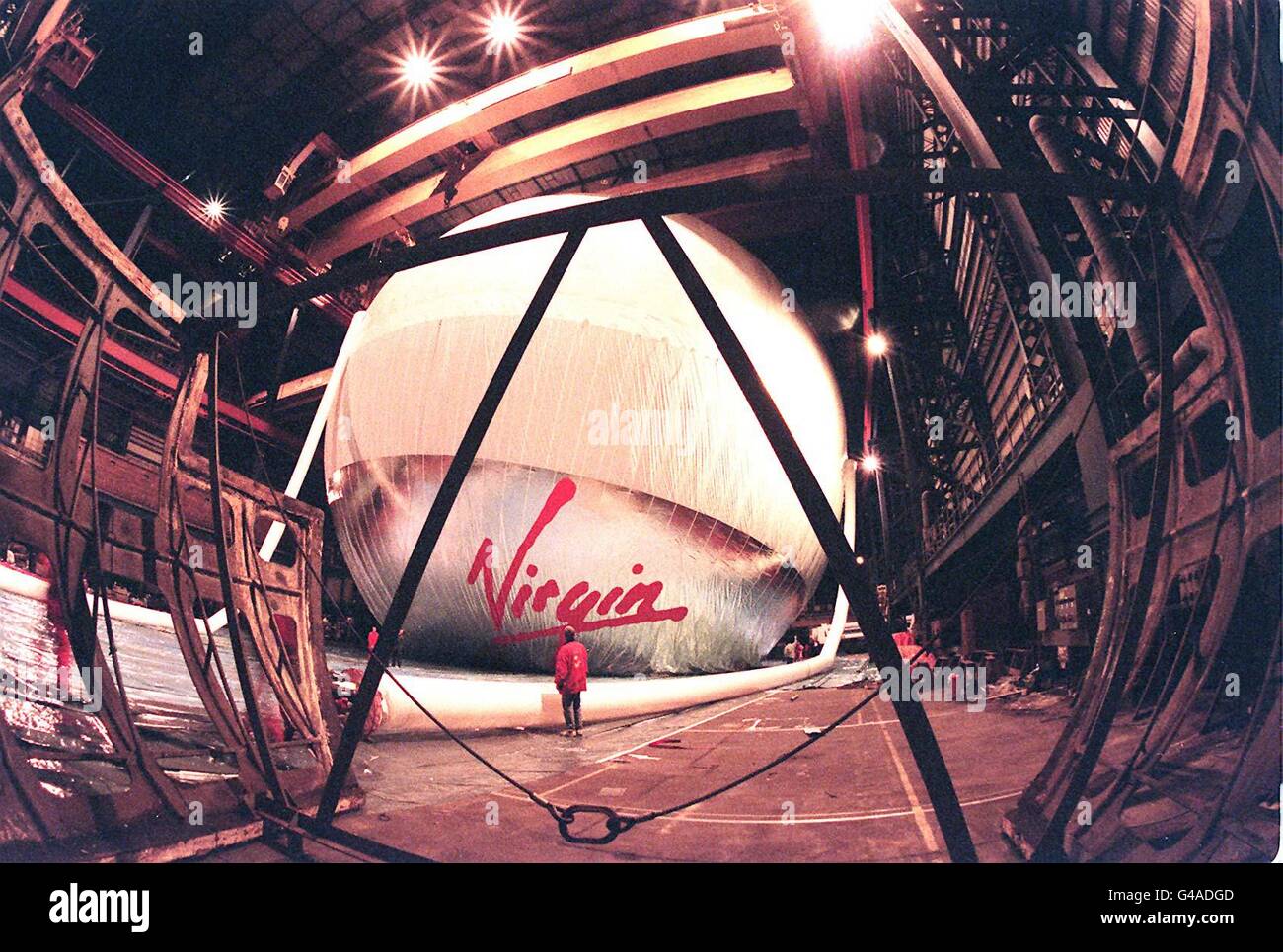 Looking like a giant beachball the 60 mtrs high VIrgin Global Challenger balloon is inflated amongst the relics of a bygone age in the huge main construction hall of Vickers Shipbuilding Engineering Ltd's Cammel Laird works in Birkenhead yesterday eveing (Saturday). Photo by Chas Breton. Stock Photo