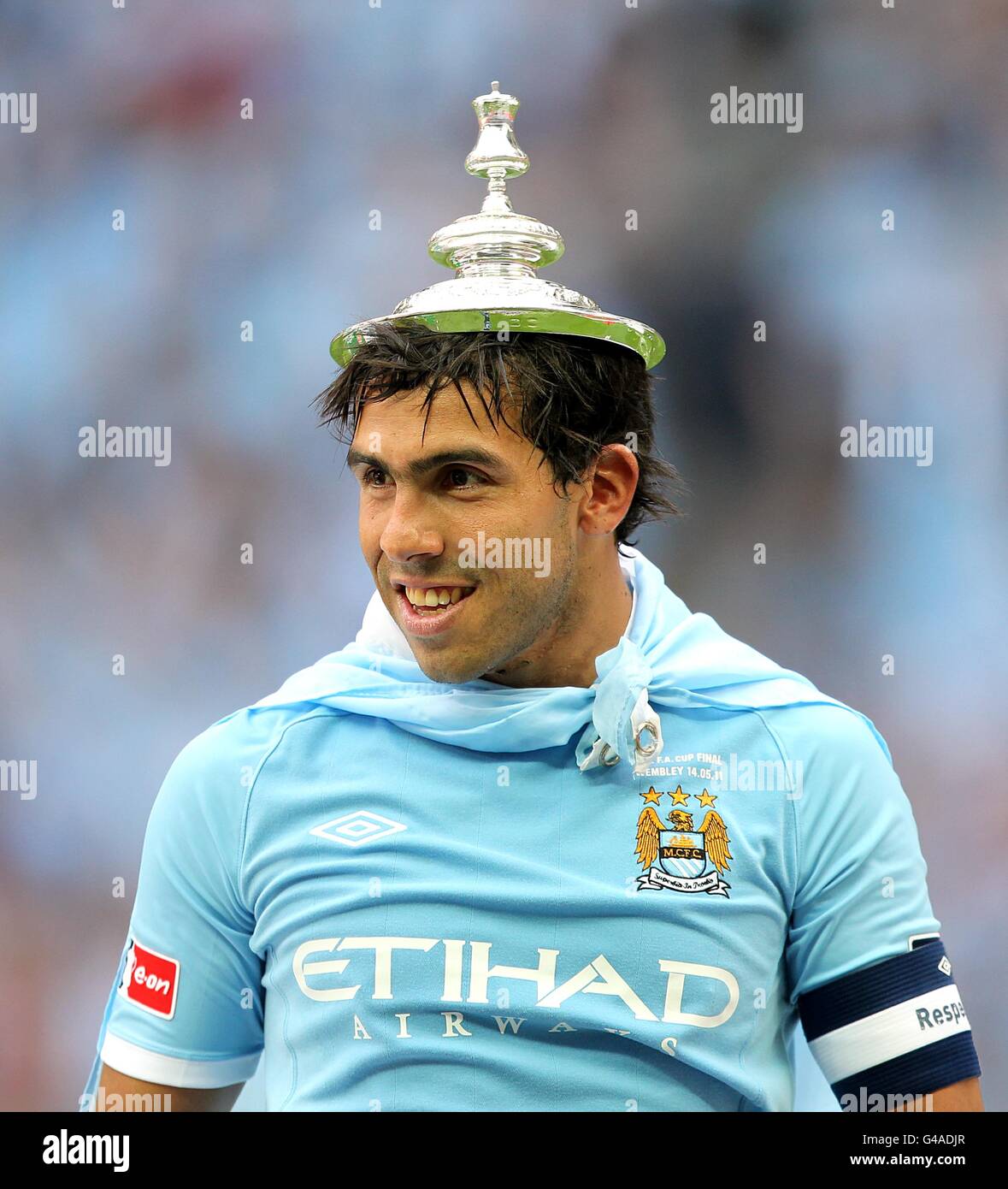 Manchester City's Carlos Tevez wears the FA Cup lid on his head after his team win the competition. Stock Photo