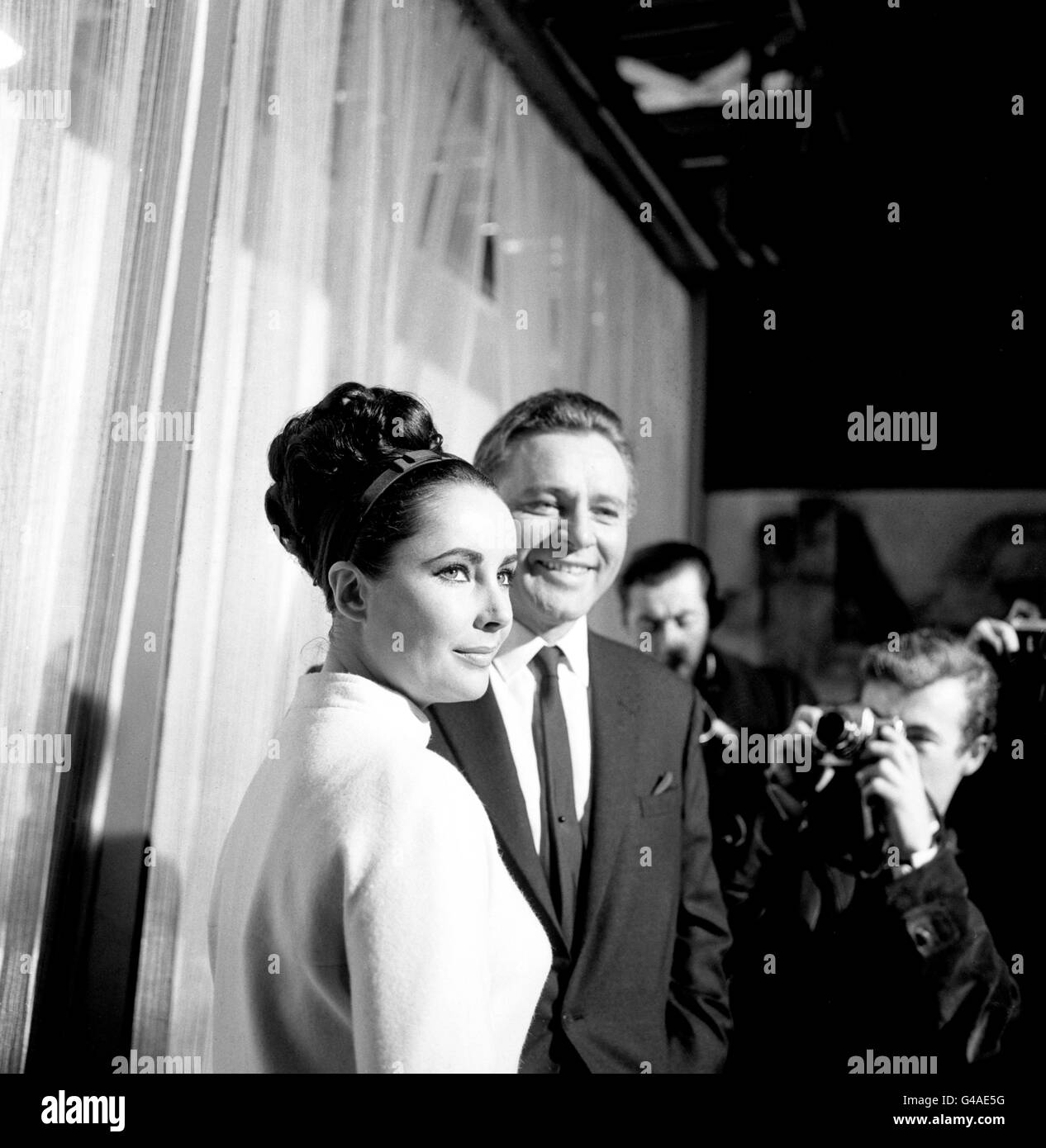 Elizabeth Taylor and Richard Burton, who play man and wife in the 'The V.I.P.'s' the new film being made at MGM's British studios at Borehamwood, Hertfordshire. Richard portrays shipping magnate Paul Andros and Elizabeth playing his wife Frances. Stock Photo