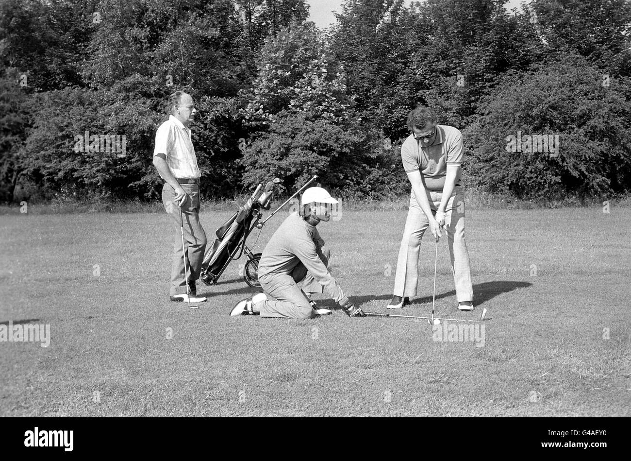 Caddy John Thornberry helps blind golfer Gerry Brereton line up for a chip shot on the course Stock Photo