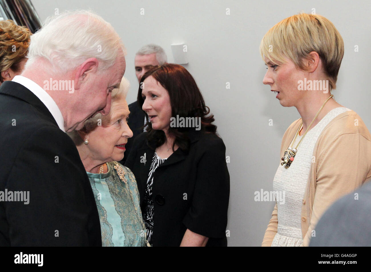 Queen Elizabeth II talks to Irish sprint hurdles athlete, Derval O'Rourke (right) at a reception and performance at the Dublin Convention Centre on the third day of the Queen's State visit to Ireland. Stock Photo
