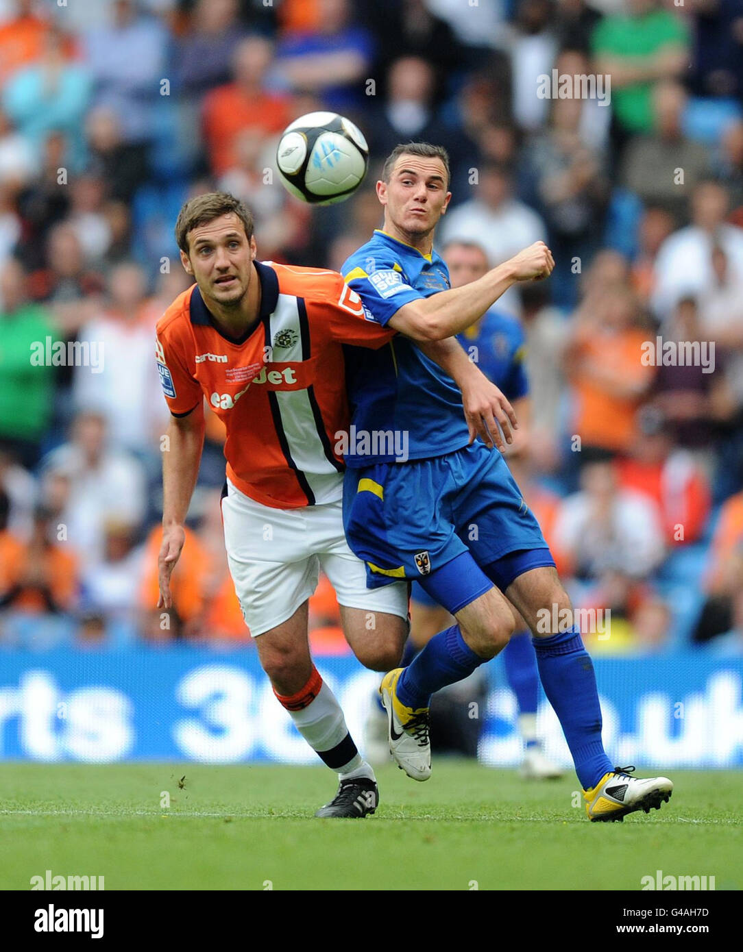 afc-wimbledon-s-luke-moore-is-challenged-by-luton-s-dan-gleeson-during