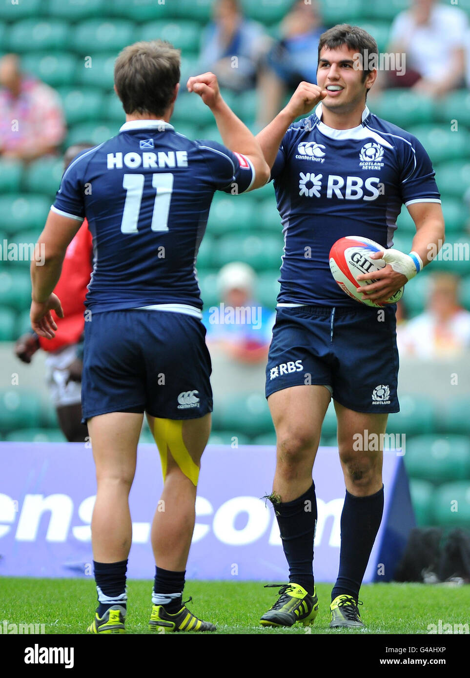 Scotland's Peter Horne (left) congratulates Stuart McInally after he scored a try during match 26 of the IRB Emirates Airline London Sevens at Twickenham Stadium, London. Stock Photo