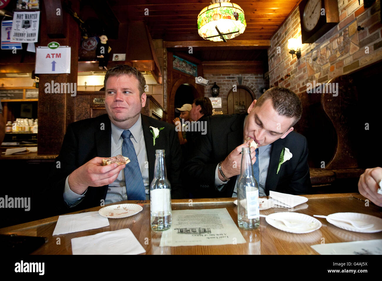 Just married, John Odum (L) and Dustin Endicott, from Birmingham, AL, eat hamburgers at Louis' Lunch in New Haven, 26 May 2009. Stock Photo