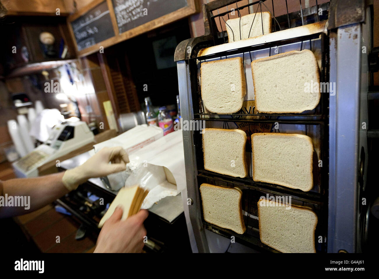Preparing toast on an old rotating toaster at Louis' Lunch hamburger joint in New Haven, CT, 26 May 2009. Stock Photo