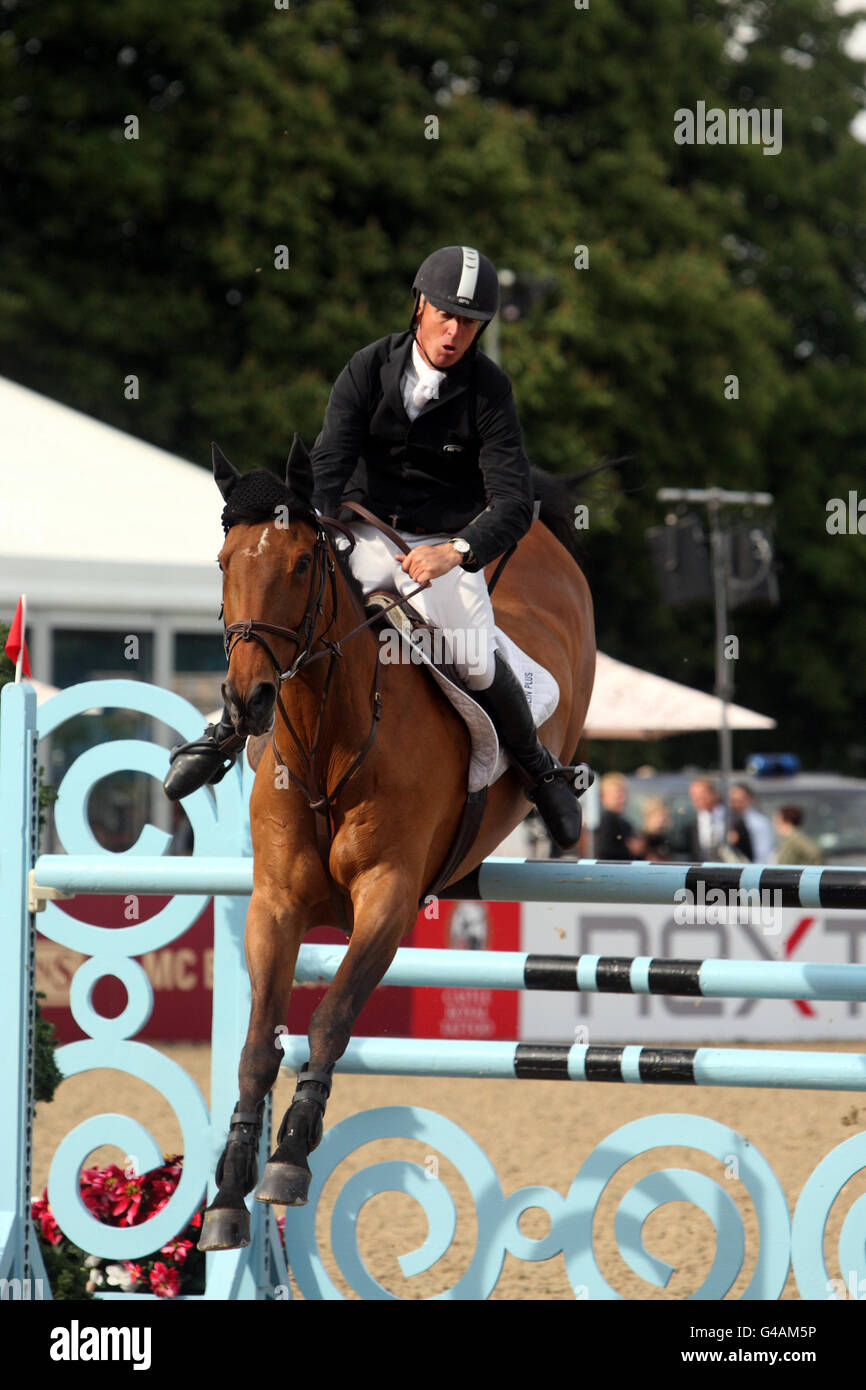 Mark Armstrong riding Thesaura competes in a jumping competition during day three of the Royal Windsor Horse Show at The Royal Mews, Windsor Castle, London. Stock Photo