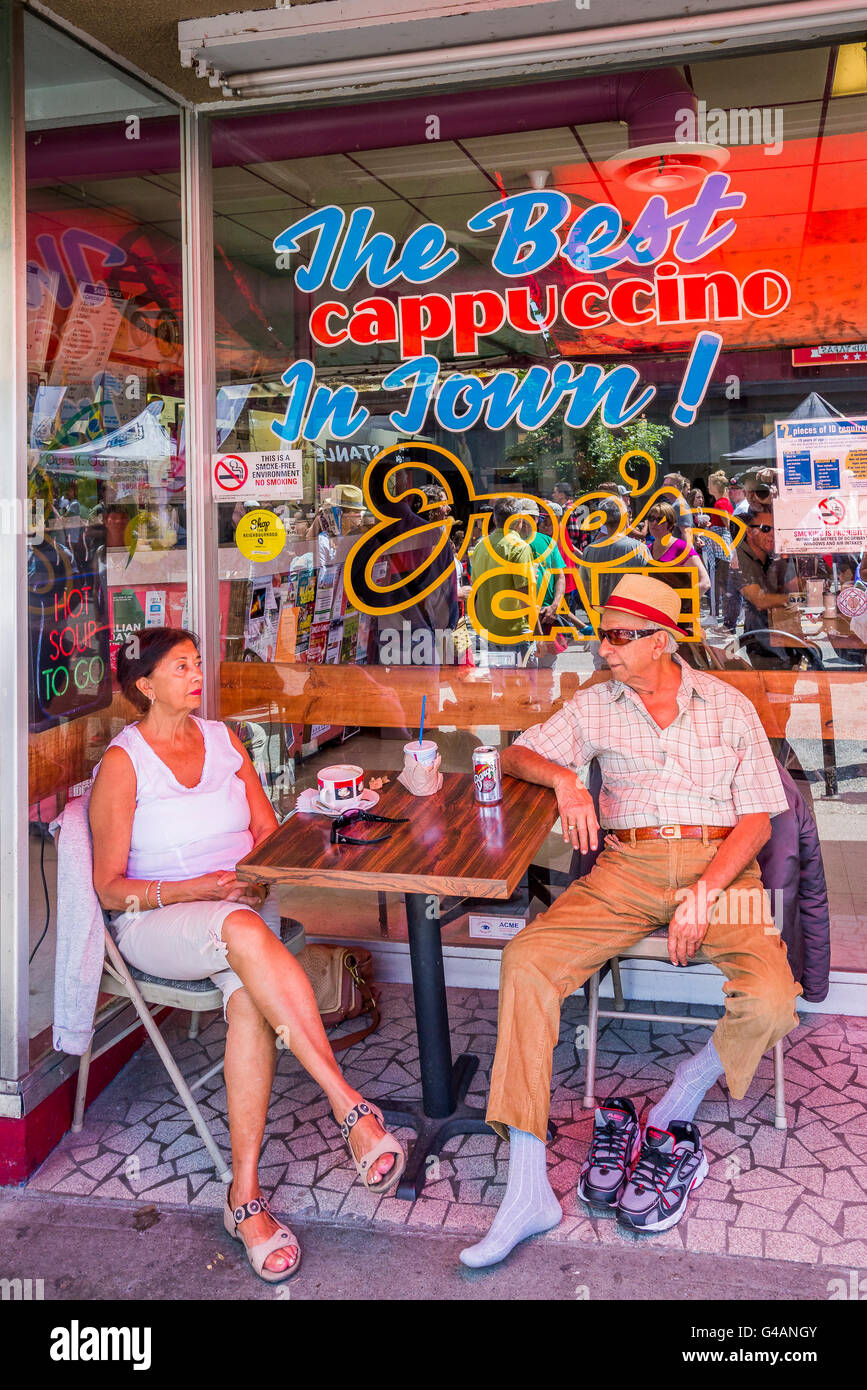 Couple have a drink outside at Joe's Cafe, Commercial Drive, Vancouver