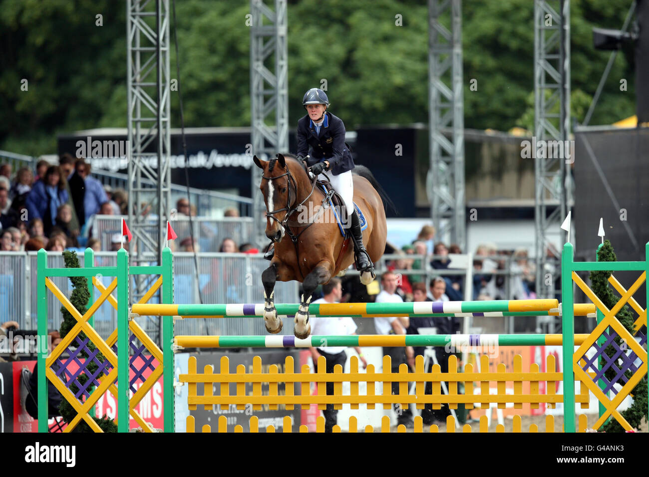 Gemma Plumley riding Chandler II competes in the The Royal Windsor Grand Prix story during day five of the Royal Windsor Horse Show at The Royal Mews, Windsor Castle, London. Stock Photo