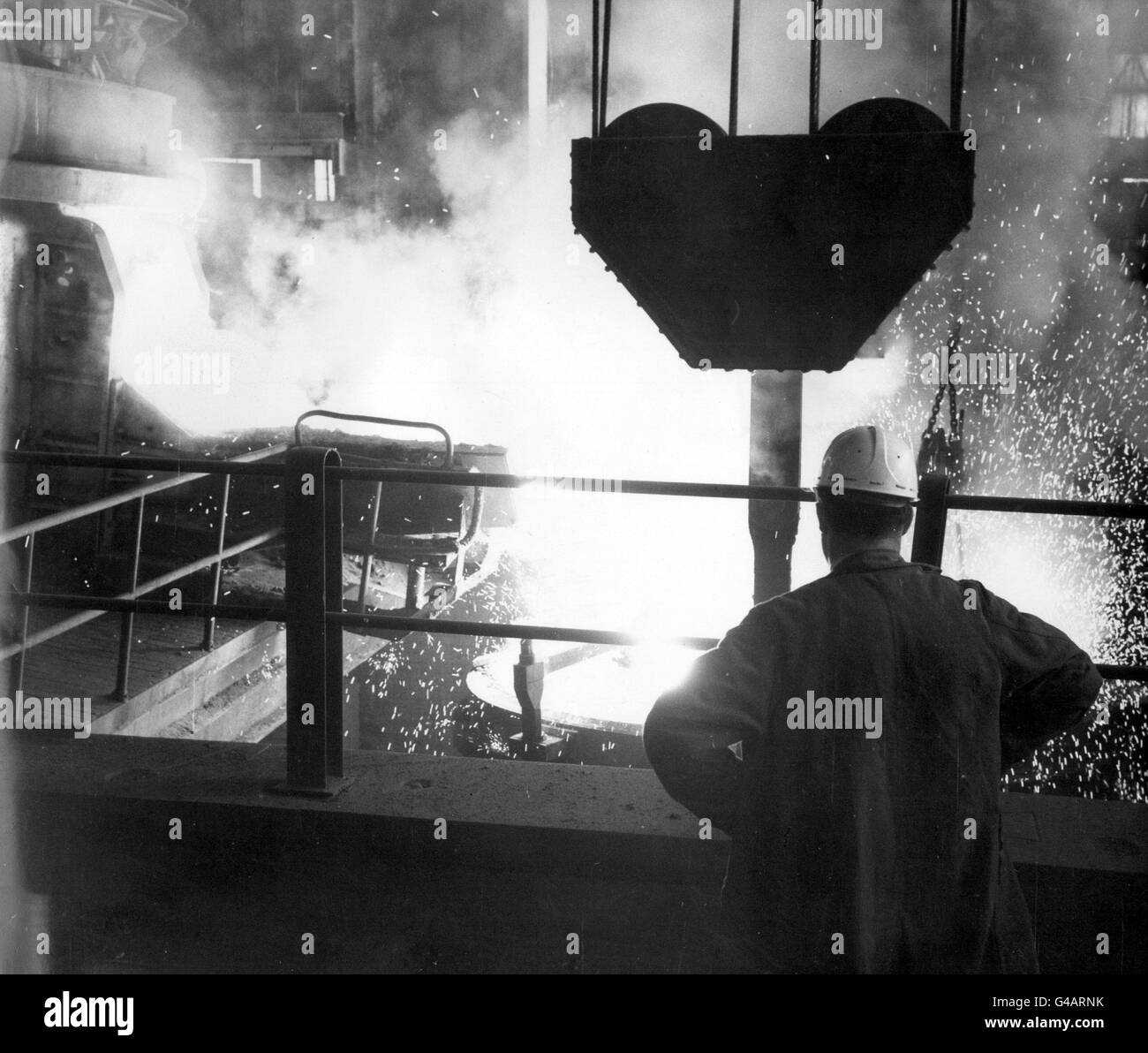 PA News,PHOTO ASSISTANT SHIFT MANAGER D. NICHOLSON AT THE STOCKSBRIDGE STEEL WORKS OBSERVING THE TAPPING OF AN ELECTRIC ARC FURNACE (POURING THE MOLTEN METAL FROM THE FURNACE INTO THE LADLE). 02/02/2004 Steel production could be cut back worldwide, including the UK, following a big increase in the cost of raw materials, a new report warned Monday February 2 2004. Stock Photo