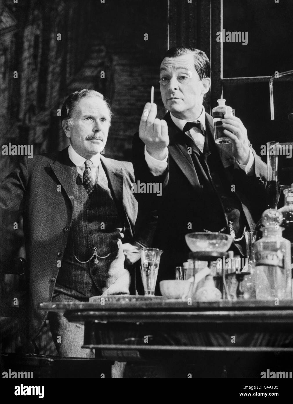 Actor Jeremy Brett (r), preparing for the title role in 'The Secret of Sherlock Holmes', gives Edward Hardwicke (Dr Watson) an elementary detection lesson at the Wyndham Theatre in London's West End where the new mystery by Jeremy Paul opens for previews. Stock Photo
