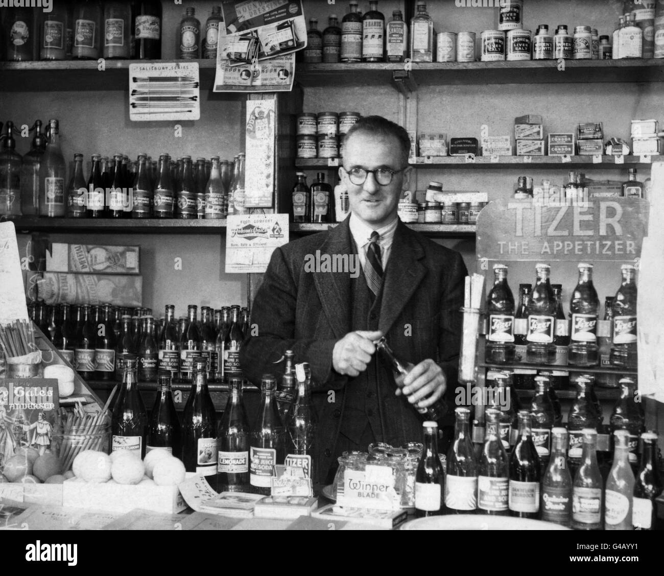 Behind the counter of his sweets and tobacco shop in Caunce Street, Blackpool, is Harold Larwood, the 44-year-old former England and Nottingham fast bowler. Mr Larwood has just accepted an offer to become an honorary member of the MCC. Stock Photo