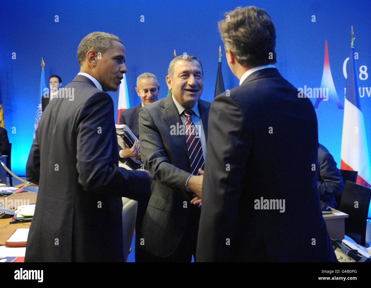 Prime Minister of Egypt Essam Sharaf (centre) shakes hands with Prime Minister David Cameron (right) as US President Barack Obama (left) looks on as they attend a meeting with G8 leaders and newly appointed Arab leaders at the G8 summit in Deauville, France, where recent changes in the Middle East and North Africa region were discussed. Stock Photo