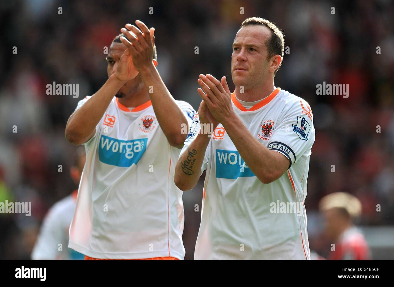 Blackpool's Charlie Adam (right) and Matt Phillips thank the travelling fans after the final whistle after their side are relegated from the Premier League Stock Photo