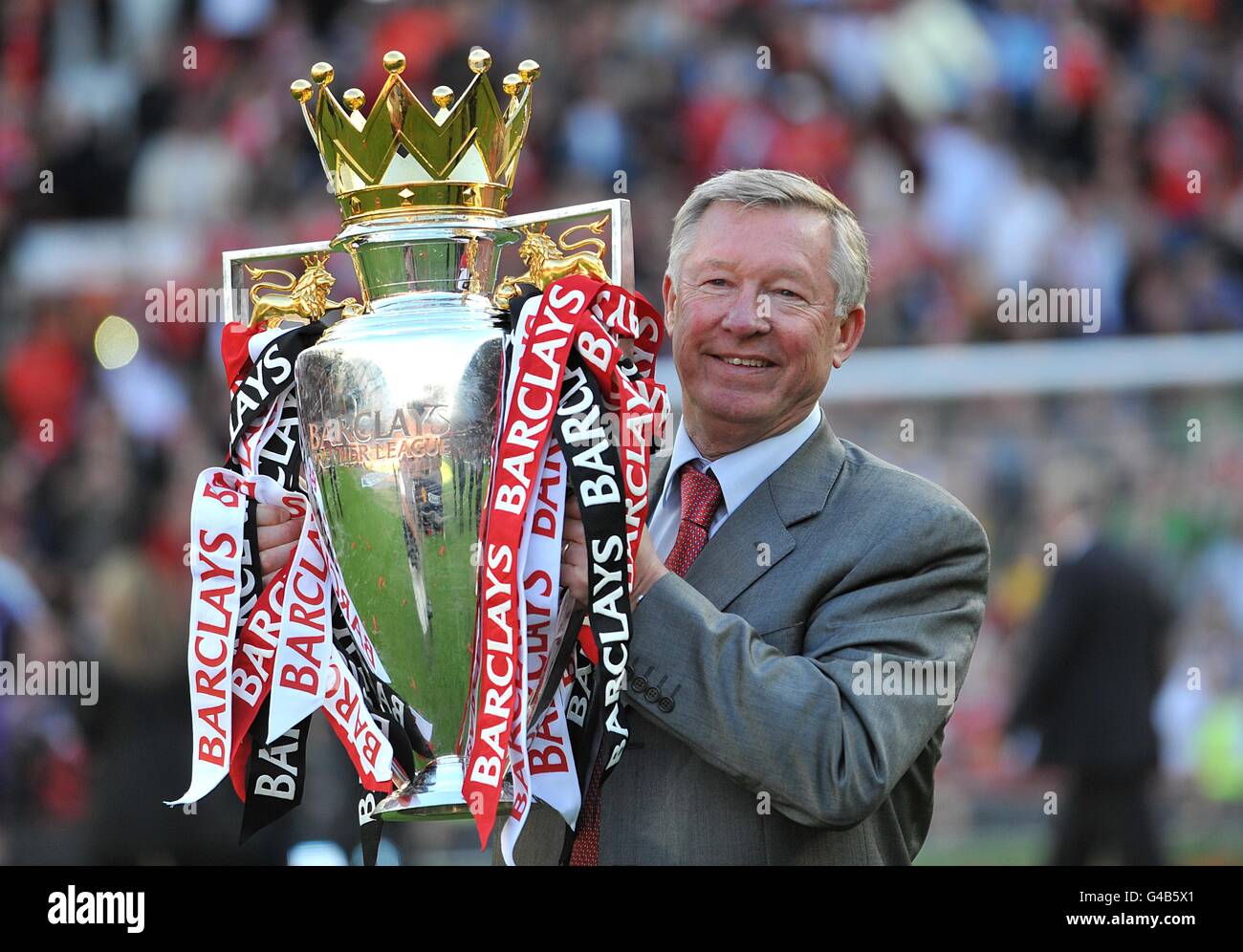 Manchester United manager Sir Alex Ferguson celebrates with the Premier  League trophy Stock Photo - Alamy