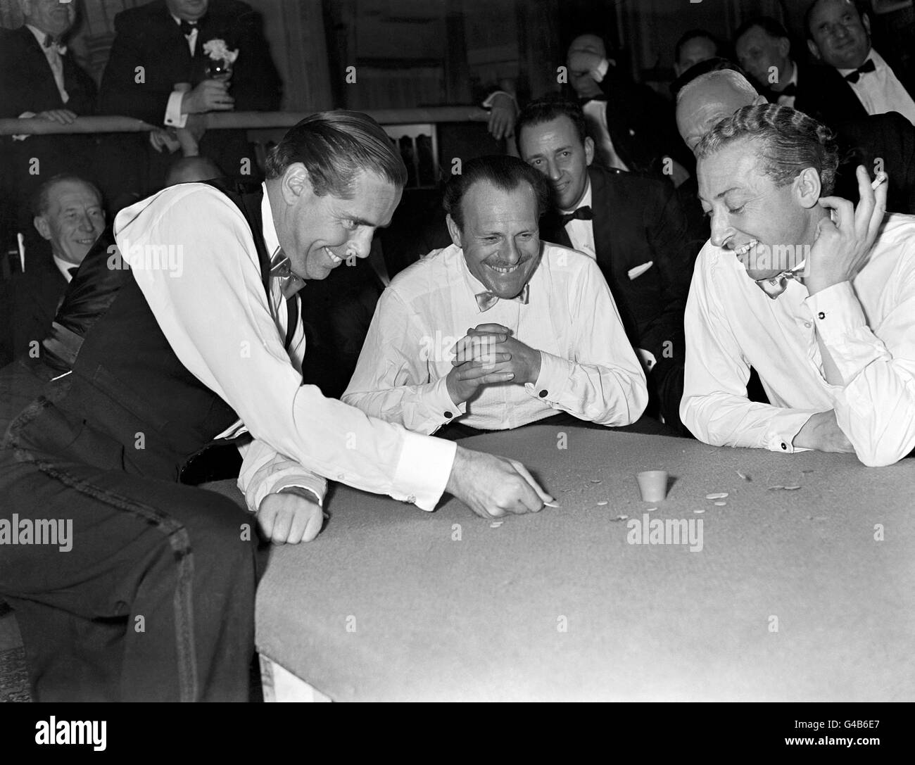 The Earl of Kimberley, left, squidges for the pot, watched by Terry Thomas (centre) and Kevin McClory. Stock Photo