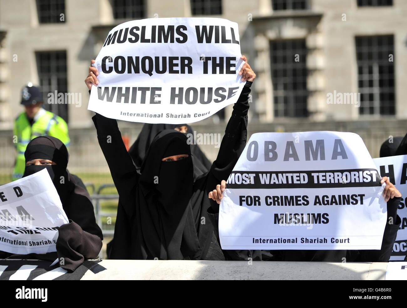 Protesters stand outside Downing Street as Barack Obama embarks on a three-day state visit to the UK. Stock Photo